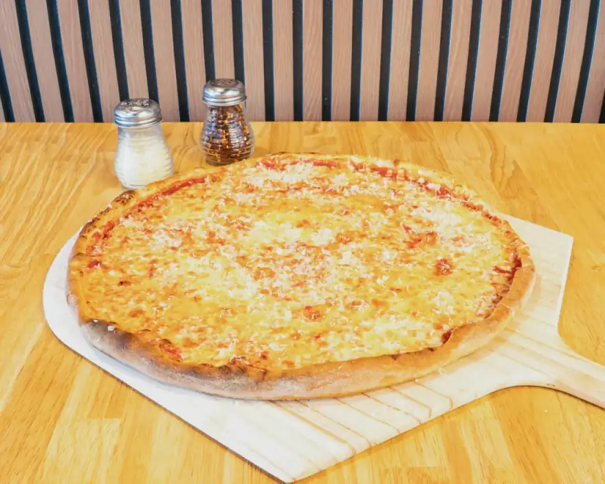 Classic NY cheese pizza on a wooden peel