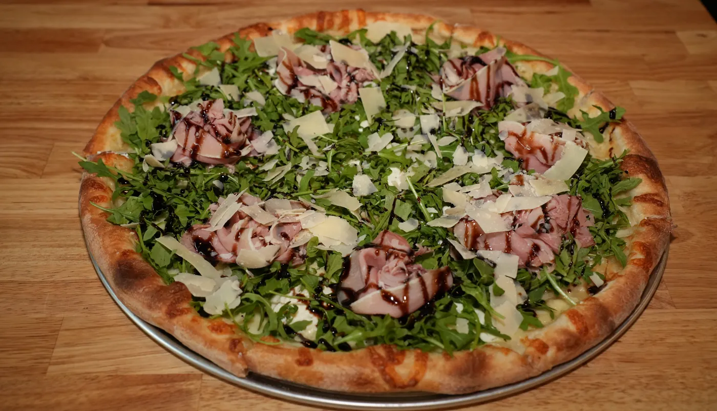 Park Avenue pizza with prosciutto, arugula and balsamic glaze